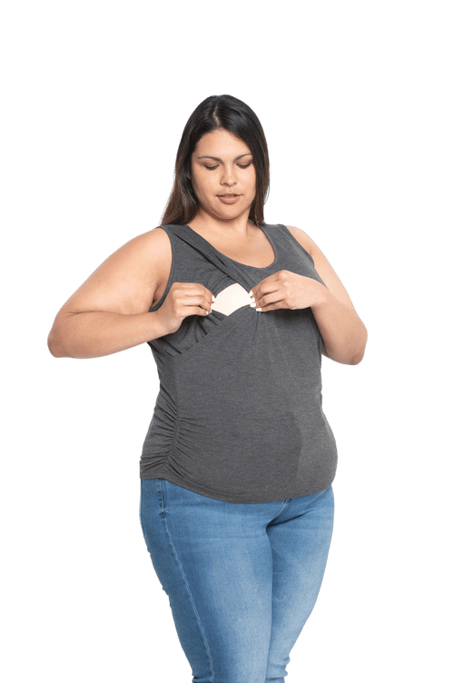 Curvy model facing camera wearing charcoal grey tank top, featuring rounded neckline and side rouching. Adrien available in sizes 6-26