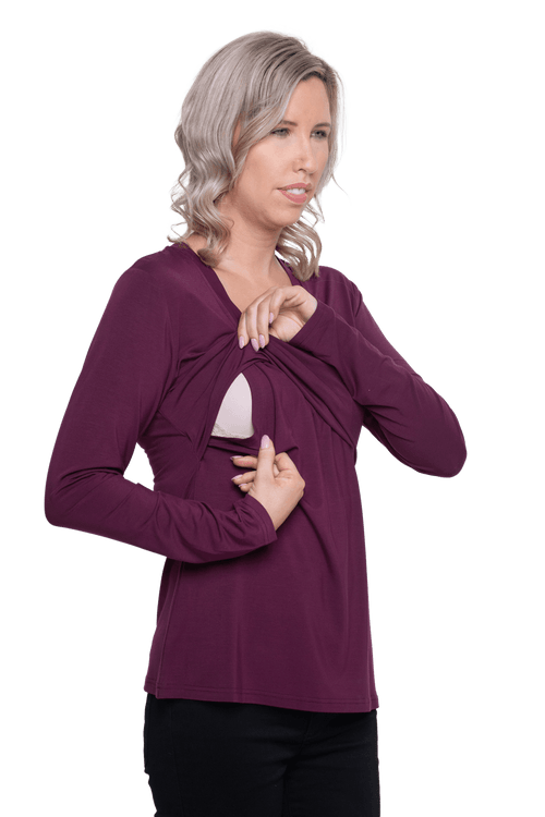 Petite model facing camera wearing burgundy, long sleeved, v-neck top, features small tie front under bust. Billie available in sizes 6-26