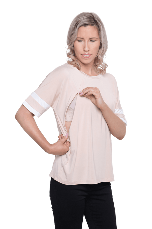 Curvy model facing camera wearing sand, short sleeved, relaxed fit top, features rounded neckline and two white varsity stripes on the sleeve. Cameron available in sizes 6-26