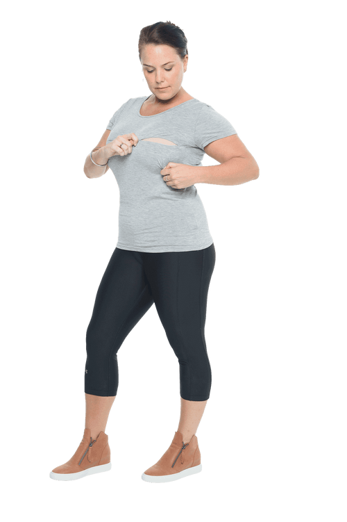 Model facing camera wearing grey, short sleeved tee, features rounded neckline. Cindy available in sizes 6-18