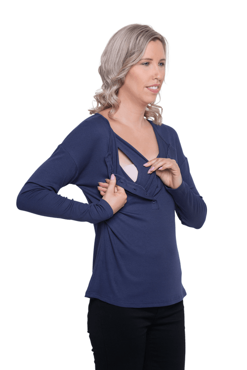 Curvy model facing camera wearing navy blue, long sleeved henley top, slightly unbuttoned. Features button front and dropped shoulder. Hunter available in sizes 6-26