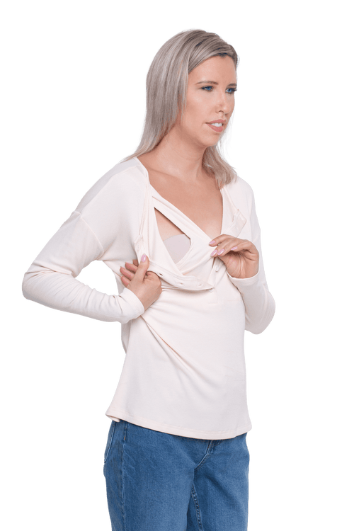 Petite model facing camera wearing sand, long sleeved henley top. Features button front and dropped shoulder. Hunter available in sizes 6-26
