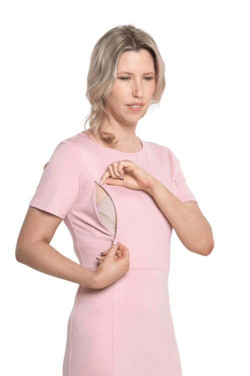 Petite model facing camera wearing pink dress, featuring rounded neckline, back zip and an elegant, fitted silhouette. Juliet available in sizes 6-18
