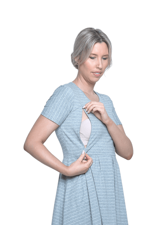 Petite model facing camera wearing grey with white pin striped, knee length dress, featuring rounded neckline, fitted bodice, pleated A-line skirt and pockets. Kaitlyn available in sizes 6-26
