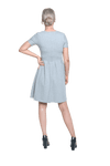 Petite model facing the back wearing grey with white pin striped, knee length dress, featuring rounded neckline, fitted bodice, pleated A-line skirt and pockets. Kaitlyn available in sizes 6-26