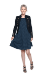 Petite model facing the camera wearing navy with white pin striped, knee length dress and black blazer, featuring rounded neckline, fitted bodice, pleated A-line skirt and pockets. Kaitlyn available in sizes 6-26