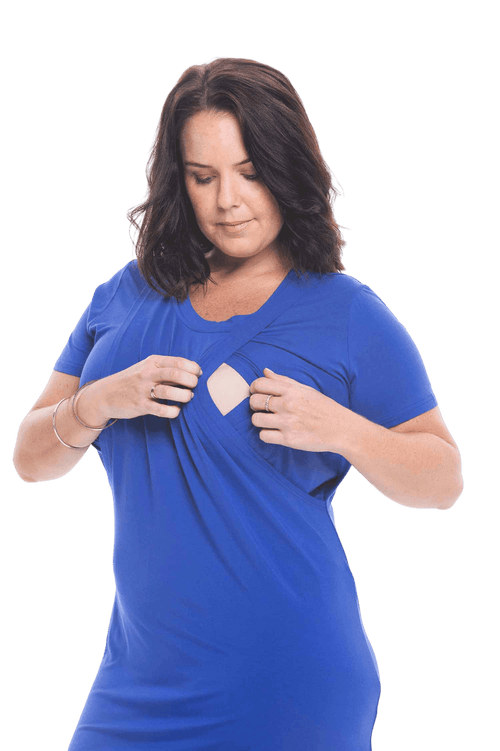Brunette model facing camera wearing royal blue mid thigh length nightie, featuring rounded neckline, scooped hemline with short sleeves. Penny available in sizes 6-18