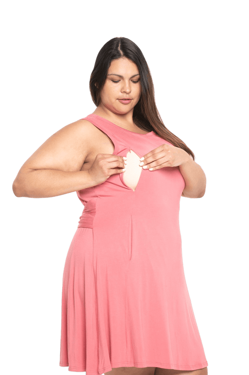 Curvy model facing camera wearing dusty pink mid thigh length dress, featuring rounded neckline, pockets and a waist sash tied at the back. Peyton available in sizes 6-26