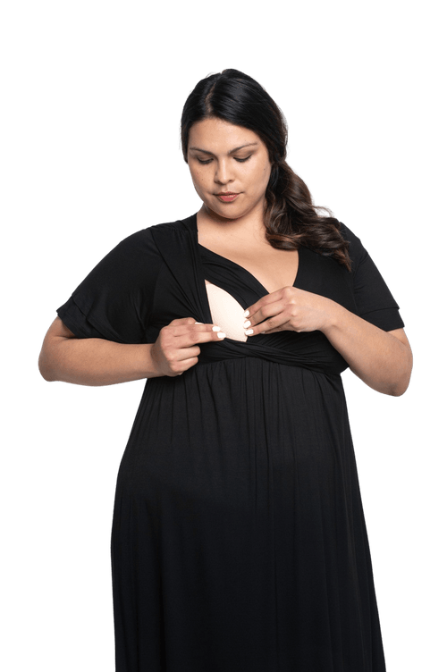 Curvy model facing camera wearing black maxi dress, featuring crossover V-neck, double layer detailed sleeves, pockets and a beautiful Grecian flowing silhouette. Phoebe available in sizes 6-26