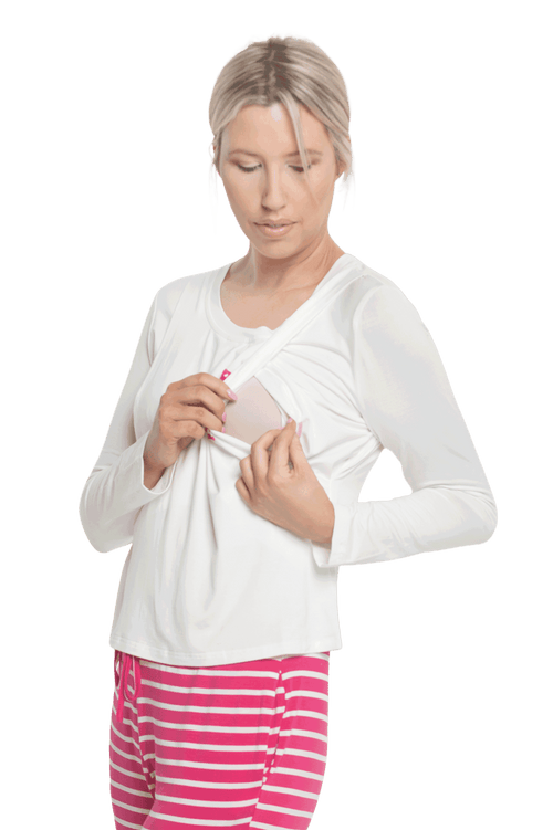 Petite model facing the camera wearing long sleeved pyjamas with pants. Top is white with contrast breast pocket matching pants. Pants are hot pink and white stripe, featuring pockets, and elasticated waist with pull tie. Piper available in sizes 6-18