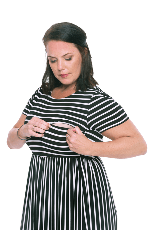 Brunette model facing the side wearing black and white striped maxi dress, featuring rounded neckline, and a gently fitted bodice, gathering above the waist. Riley available in sizes 6-18