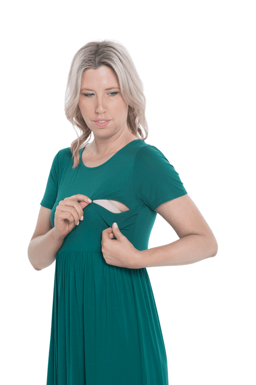 Petite model facing the camera wearing bottle green maxi dress, featuring  rounded neckline, and a gently fitted bodice, gathering above the waist. Riley available in sizes 6-26