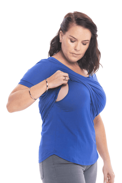 Petite model facing the camera wearing cobalt blue short sleeved tee, featuring rounded neckline, and scooped hem. Stevie available in sizes 6-18