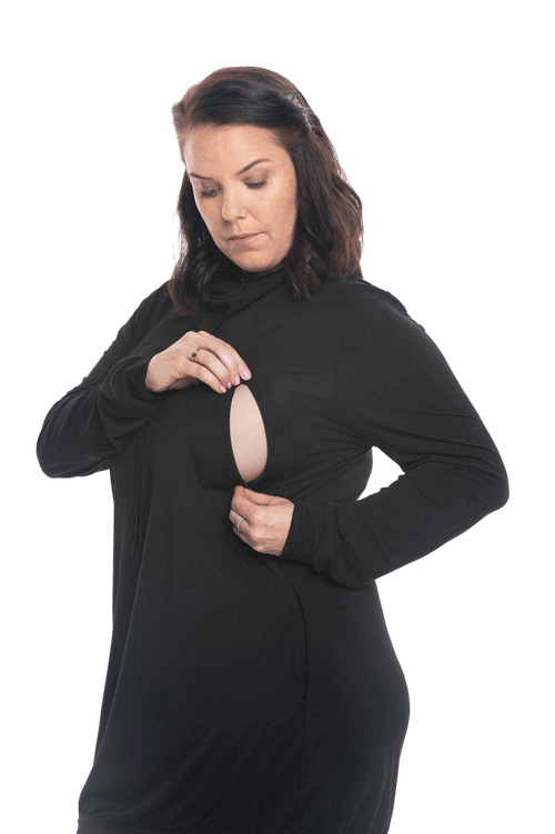 Brunette model facing the camera wearing black long sleeved tunic as a dress with boots, featuring pockets and a faux hoodie collar in a comfy, relaxed fit. Tori available in sizes 6-18