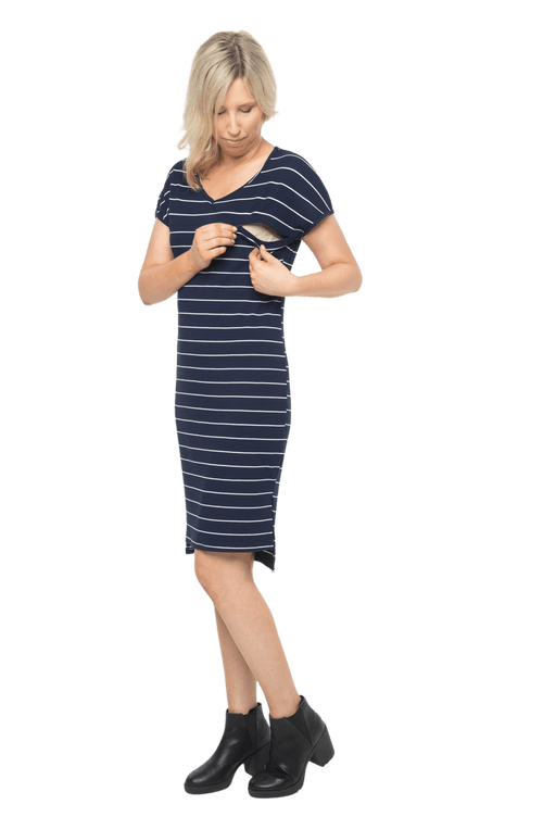 Petite model facing the camera wearing navy with white pin striped shift dress, featuring slight v neck and side splits. Zoe available in sizes 6-18