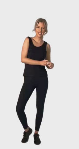 Petite model wearing black, tank top, features rounded neckline. Drew available in sizes 6-26