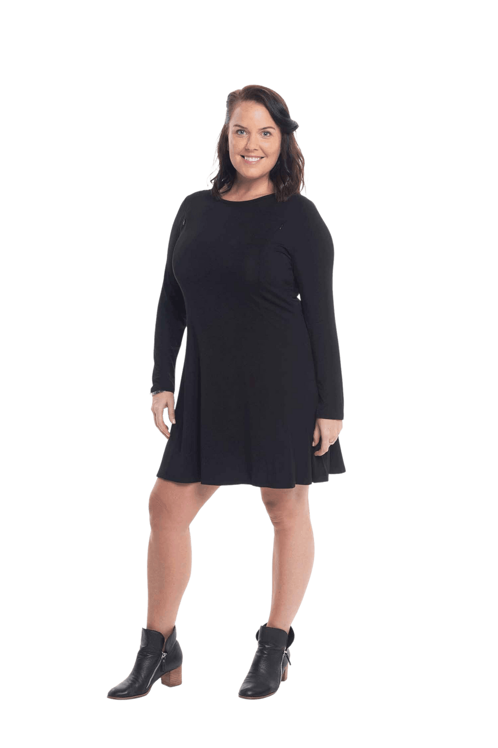 Brunette model facing the side wearing black A-line swing dress, featuring rounded neckline. Amber available in sizes 6-26