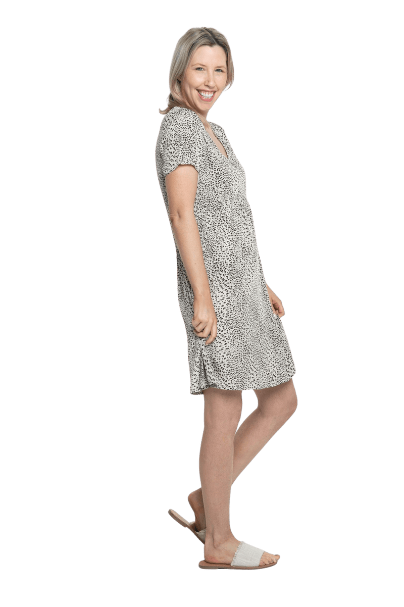 Petite model facing the side wearing knee length, leopard print dress, featuring soft v-neck. Avery available in sizes 6-26