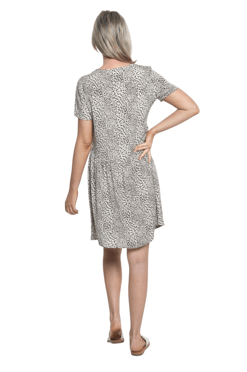 Petite model facing the back wearing knee length, leopard print dress, featuring soft v-neck. Avery available in sizes 6-26