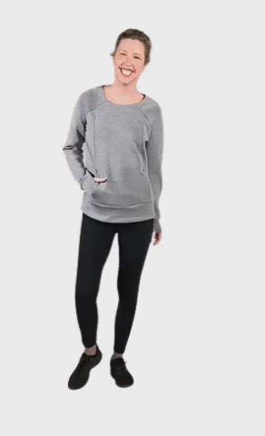Model wearing grey crew necked jumper, featuring thick, flat waist band, thumb holes, and pockets. Cassie available in sizes 6-26