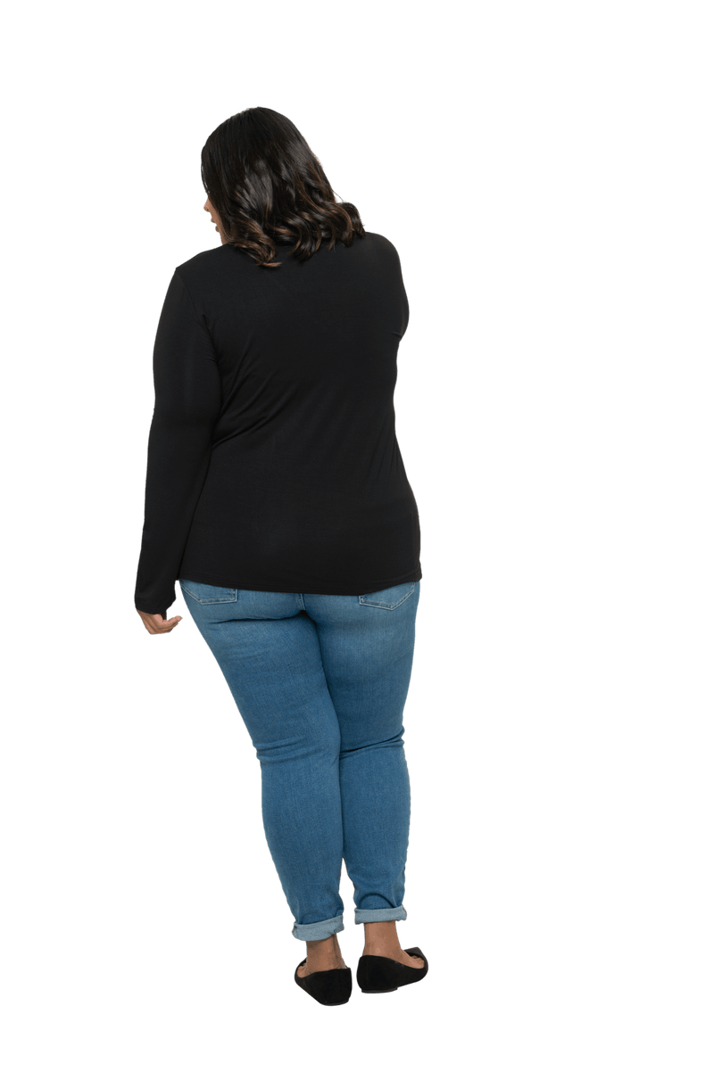 Curvy model facing the back wearing black, long sleeved, v-neck top, features small tie front under bust. Billie available in sizes 6-26