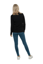 Petite model facing the back wearing black, long sleeved, v-neck top, features small tie front under bust. Billie available in sizes 6-26