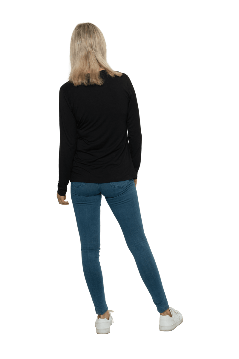 Petite model facing the back wearing black, long sleeved, v-neck top, features small tie front under bust. Billie available in sizes 6-26