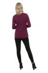 Petite model facing the back wearing burgundy, long sleeved, v-neck top, features small tie front under bust. Billie available in sizes 6-26