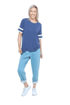 Petite model facing camera wearing navy blue, short sleeved, relaxed fit top, features rounded neckline and two white varsity stripes on the sleeve. Cameron available in sizes 6-26