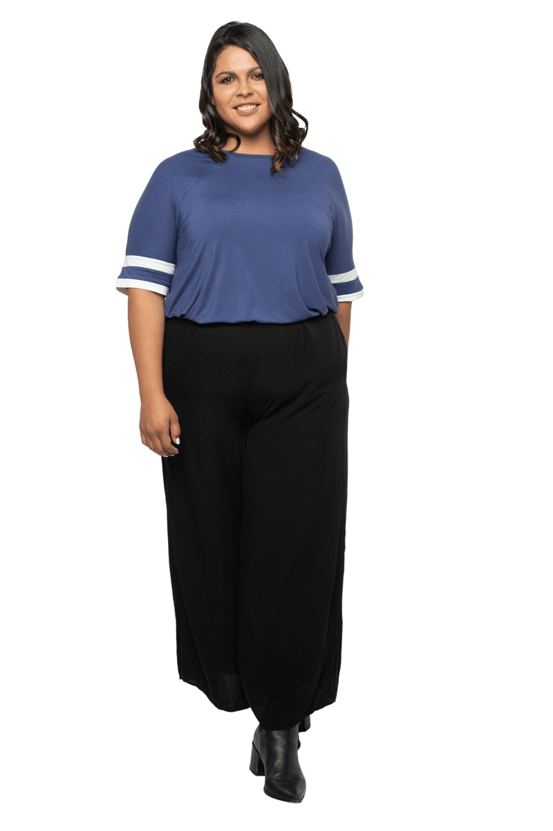 Curvy model facing camera wearing navy blue, short sleeved, relaxed fit top, features rounded neckline and two white varsity stripes on the sleeve. Cameron available in sizes 6-26