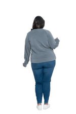 Curvy model facing the back wearing grey crew necked jumper, featuring thick, flat waist band, thumb holes, and pockets. Cassie available in sizes 6-26