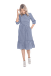 Model facing camera wearing blue gingham, mid-length sleeved midi dress, features rounded neckline, tiered skirt and pockets. Dorothy available in sizes 6-18