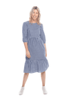 Model facing camera wearing blue gingham, mid-length sleeved midi dress, features rounded neckline, tiered skirt and pockets. Dorothy available in sizes 6-18