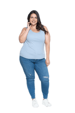 Curvy model facing camera wearing light blue tank top, features rounded neckline. Drew available in sizes 6-26