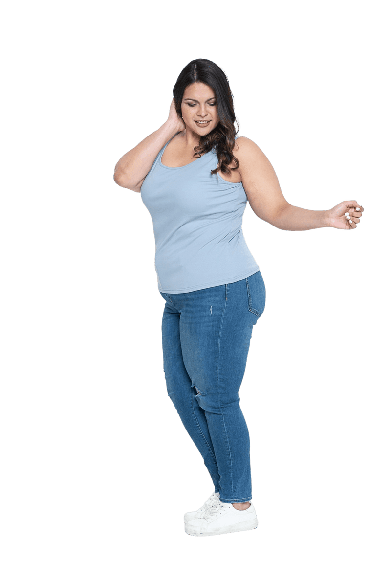 Curvy model facing the side wearing light blue tank top, features rounded neckline. Drew available in sizes 6-26
