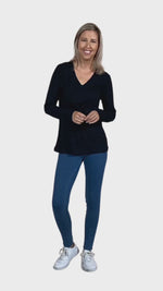 Petite model wearing black, long sleeved, v-neck top, features small tie front under bust. Billie available in sizes 6-26