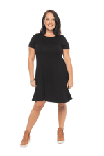 Model facing camera wearing black, short sleeved, knee length, A-line dress. Features rounded neckline. Emma available in sizes 6-18