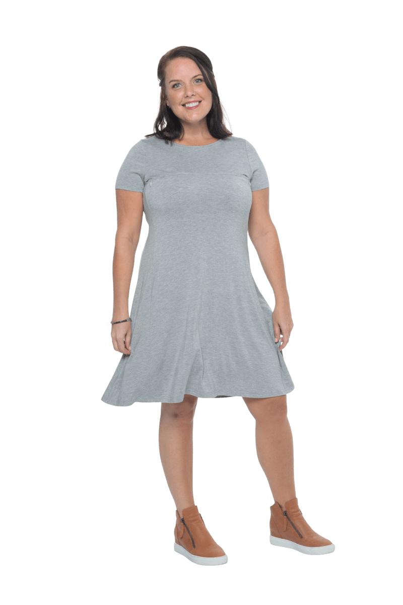 Model facing camera wearing grey, short sleeved, knee length, A-line dress. Features rounded neckline. Emma available in sizes 6-18