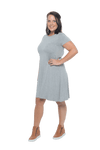 Model facing the side wearing grey, short sleeved, knee length, A-line dress. Features rounded neckline. Emma available in sizes 6-18