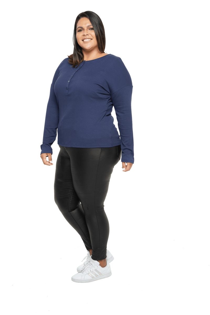 Curvy model facing the side wearing navy blue, long sleeved henley top. Features button front and dropped shoulder. Hunter available in sizes 6-26