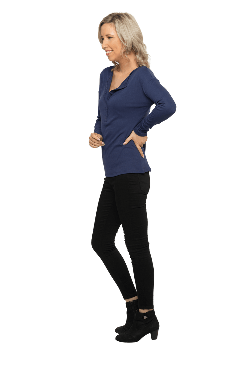 Petite model facing the side wearing navy blue, long sleeved henley top. Features button front and dropped shoulder. Hunter available in sizes 6-26