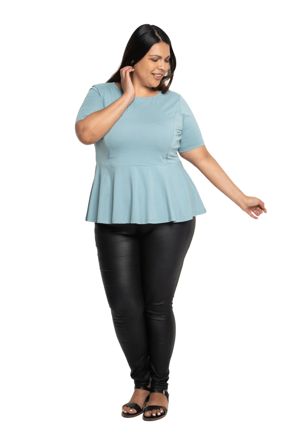 Curvy model facing camera wearing light blue short sleeved top. Featuring rounded neckline and peplum tier under bust. Isla available in sizes 6-26
