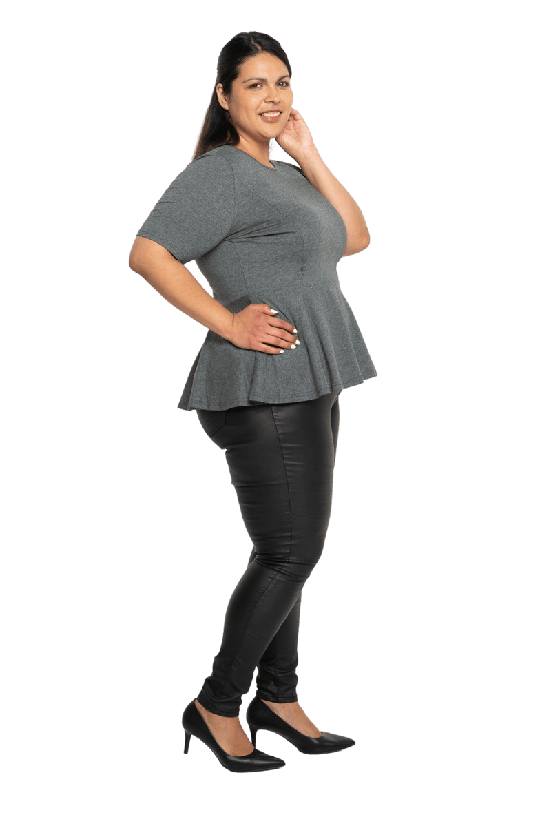 Curvy model facing the side wearing charcoal grey short sleeved top. Featuring rounded neckline and peplum tier under bust. Isla available in sizes 6-26