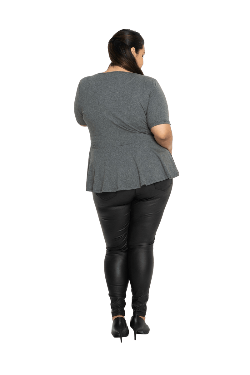 Curvy model facing the back wearing charcoal grey short sleeved top. Featuring rounded neckline and peplum tier under bust. Isla available in sizes 6-26