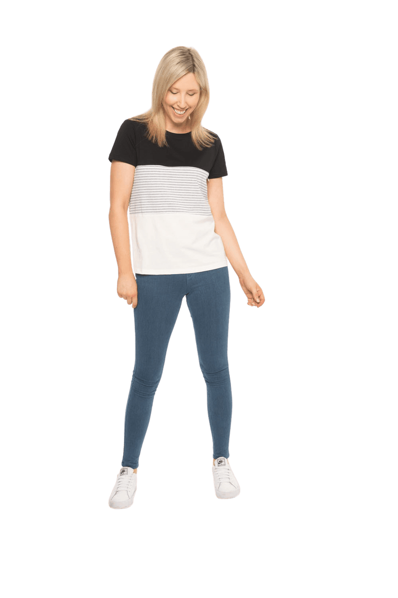 Petite model facing camera wearing colour blocked, short sleeved tee. Colour block is black in top third, grey & white stripe in middle third, white in bottom third. Features rounded neckline. Jamie available in sizes 6-26