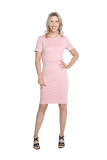 Petite model facing camera wearing pink dress, featuring rounded neckline, back zip and an elegant, fitted silhouette. Juliet available in sizes 6-18