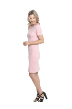 Petite model facing the side wearing pink dress, featuring rounded neckline, back zip and an elegant, fitted silhouette. Juliet available in sizes 6-18
