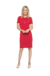 Petite model facing camera wearing red dress, featuring rounded neckline, back zip and an elegant, fitted silhouette. Juliet available in sizes 6-18