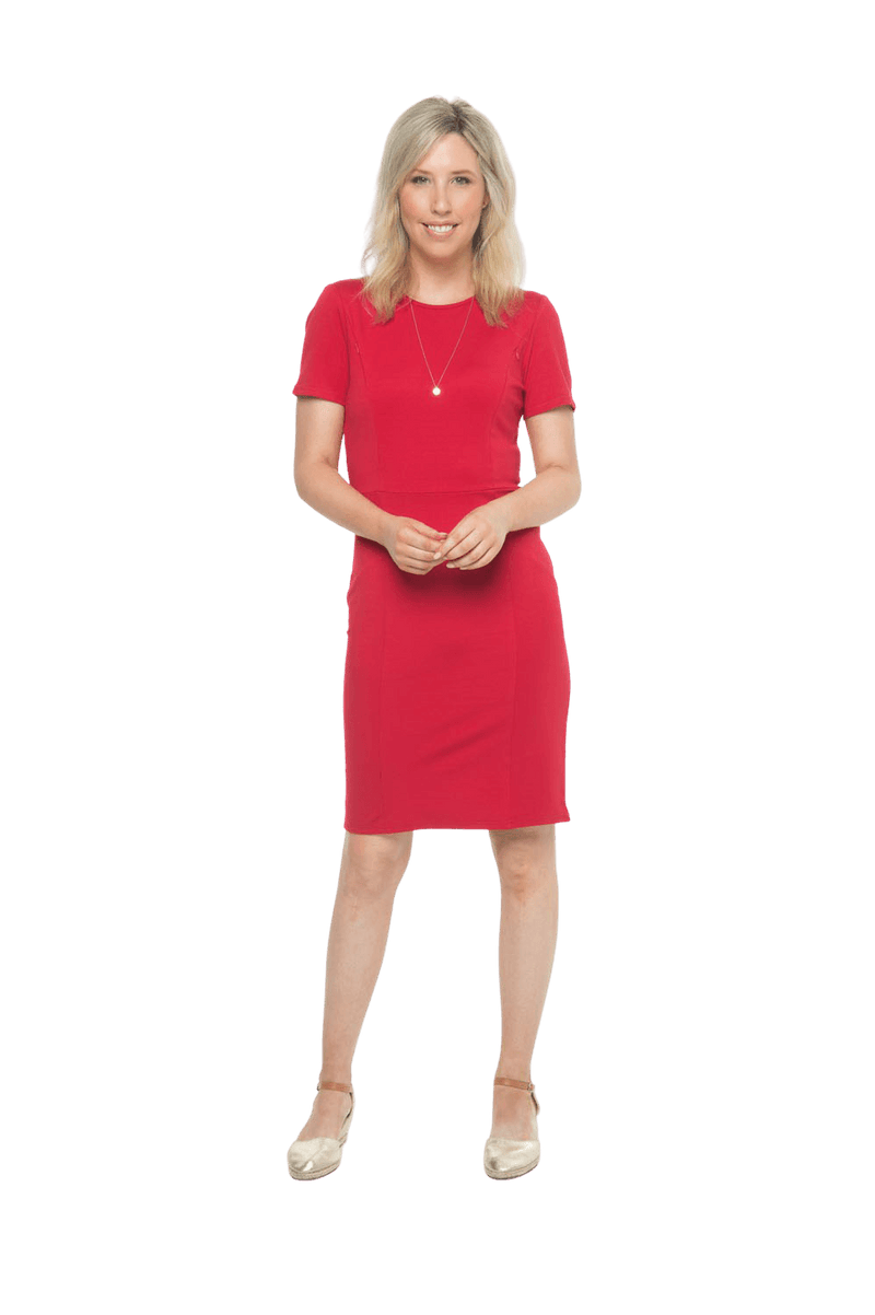 Petite model facing camera wearing red dress, featuring rounded neckline, back zip and an elegant, fitted silhouette. Juliet available in sizes 6-18