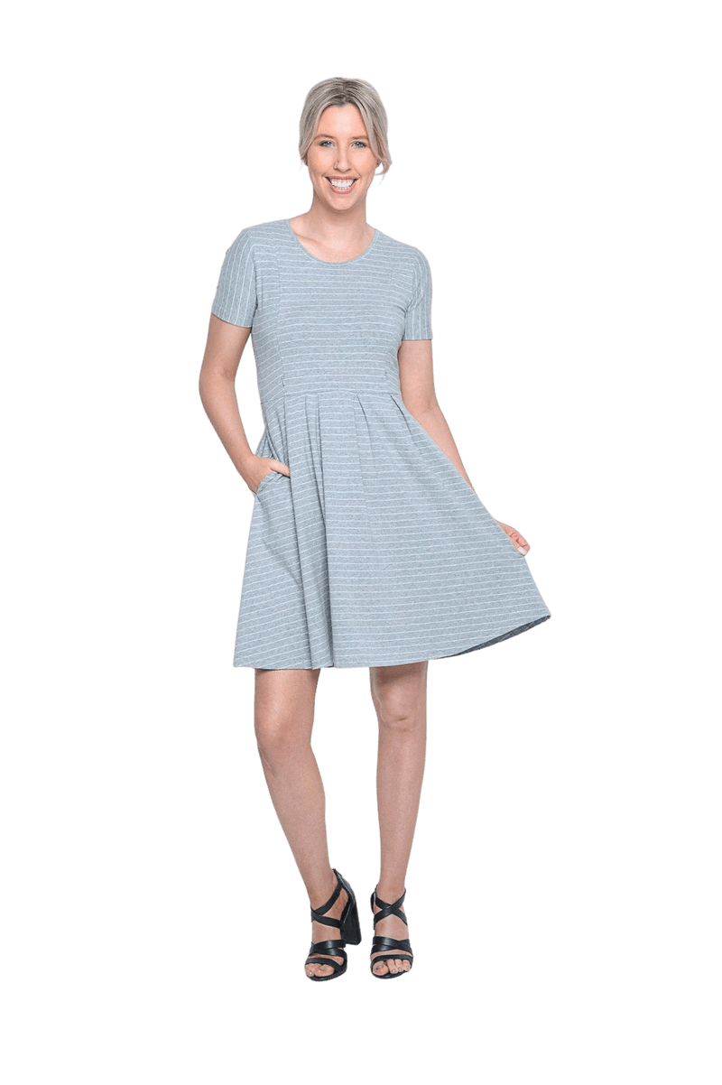 Petite model facing camera wearing grey with white pin striped, knee length dress, featuring rounded neckline, fitted bodice, pleated A-line skirt and pockets. Kaitlyn available in sizes 6-26